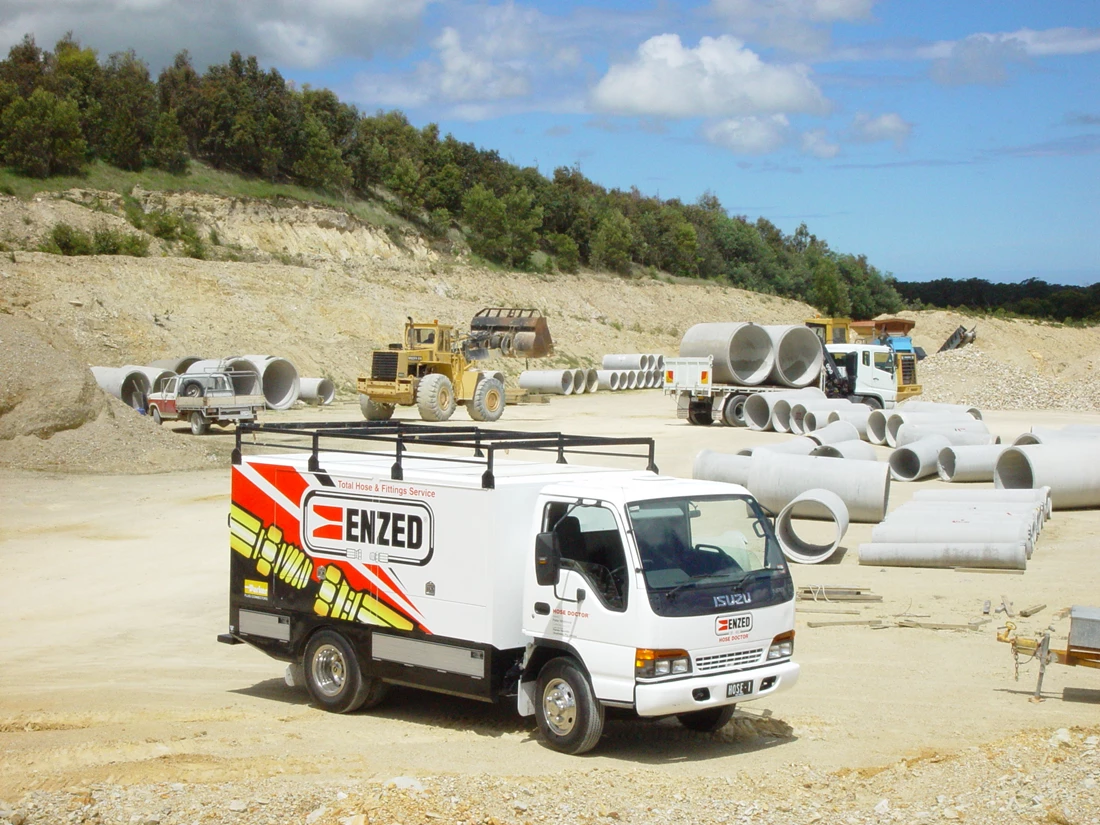 ENZED HOSE DOCTOR beside a service truck