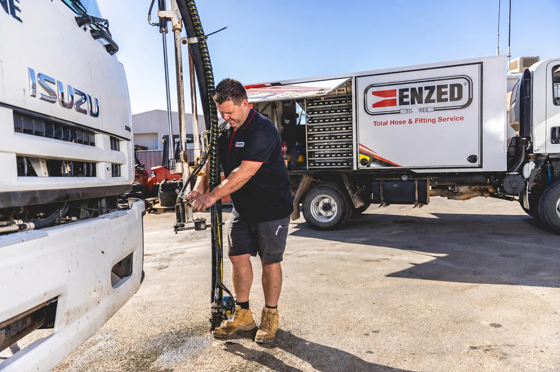 ENZED HOSE DOCTOR beside a service truck