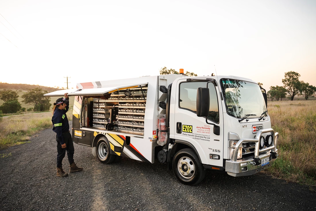 ENZED HOSE DOCTOR beside a service truck