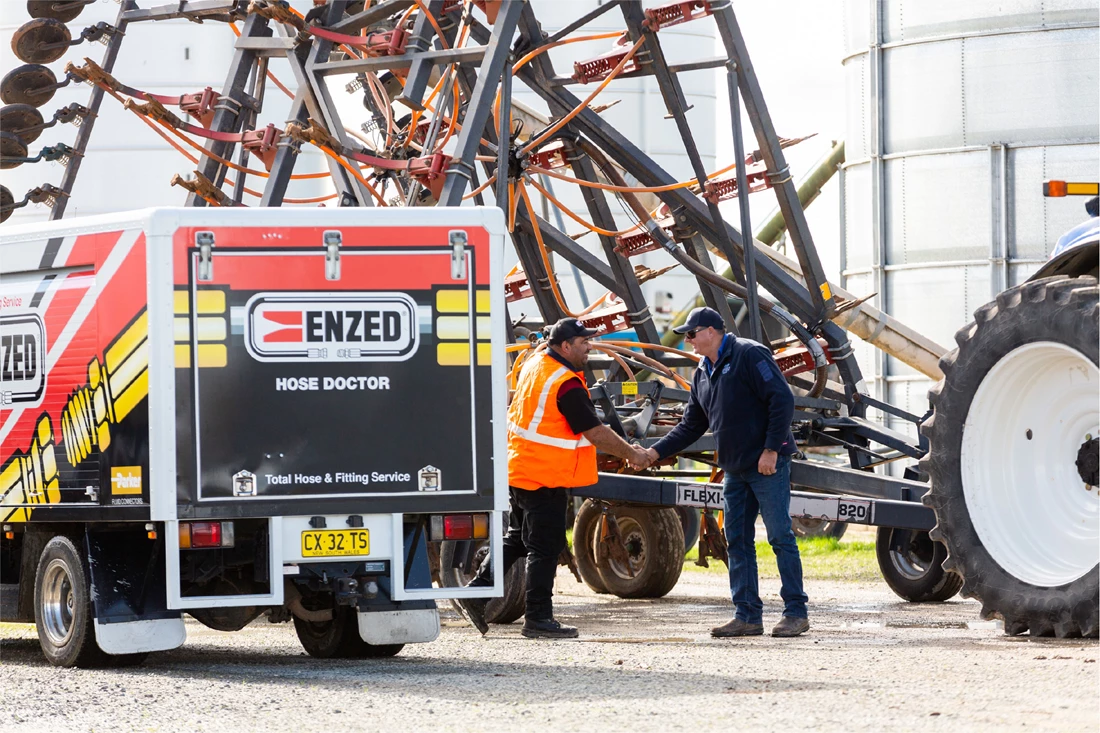 ENZED HOSE DOCTOR beside a service truck