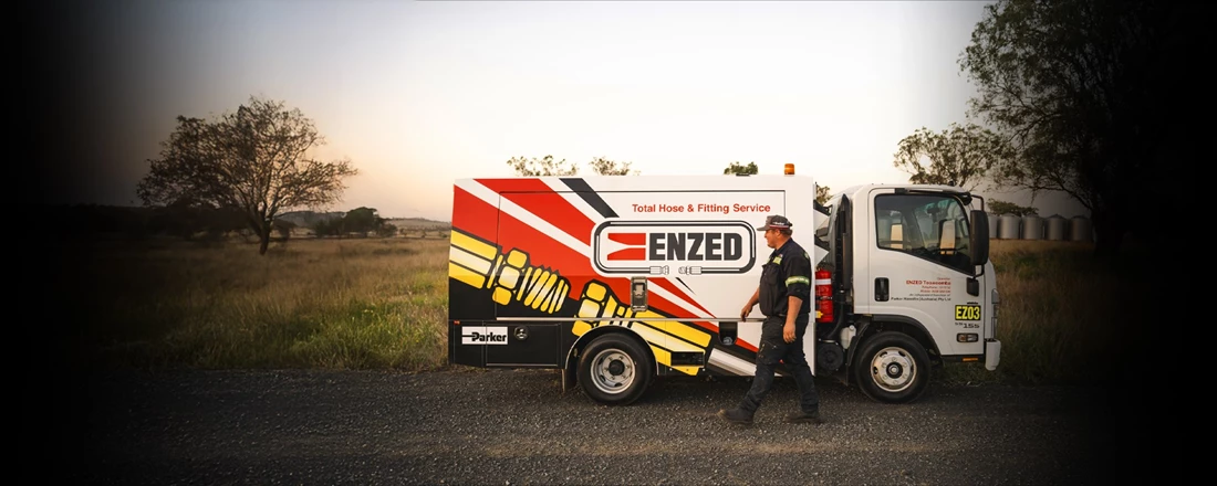 ENZED HOSE DOCTOR working beside a service truck